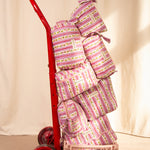 Collection de trousses Flora Lilas de Byzantine, rayures fleuries rose et violet, sur un diable rouge
