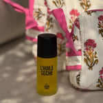 Trousses de toilette N°50 Rose avec un flacon d'huile sèche