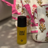Trousses de toilette N°50 Rose avec un flacon d'huile sèche