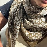 Gros plan sur le grand foulard Antioche Kaki porté au cou