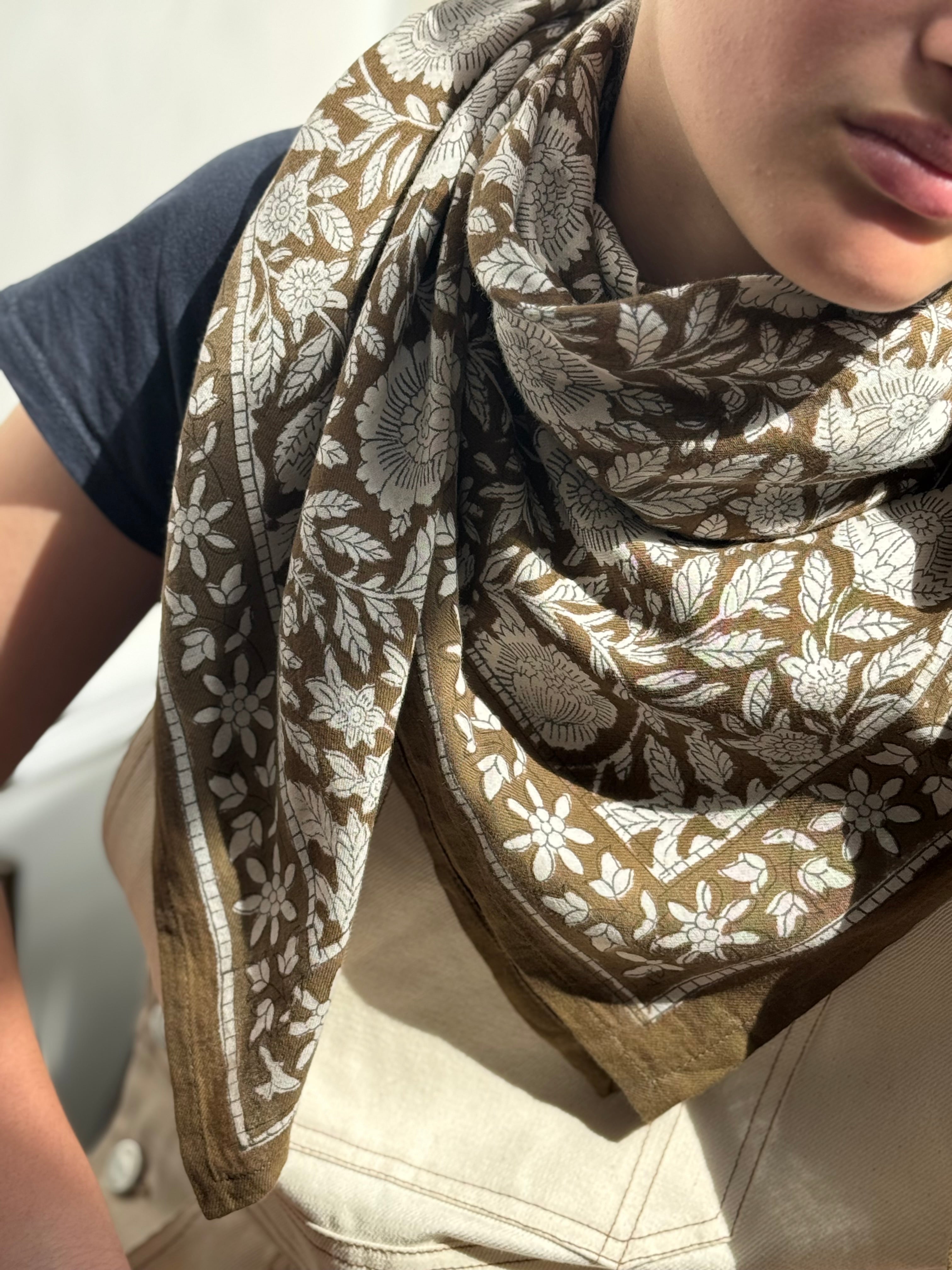 Gros plan sur le grand foulard Antioche Kaki porté au cou