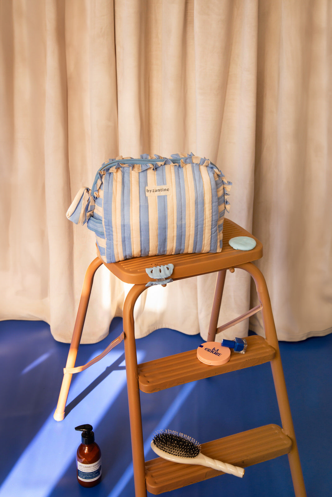 Grande trousse à volants Pacha Bleu ciel de Byzantine, sur un escabeau en bois