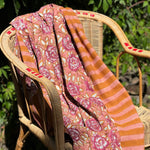 Nappe N°113 Vieux rose drapée sur un fauteuil en rotin dans un jardin