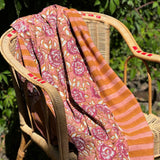 Nappe N°113 Vieux rose drapée sur un fauteuil en rotin dans un jardin