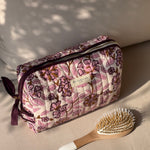 Trousse de toilette Carthage Prune de byzantine, fleurs prune sur fond rose pâle, avec une brosse