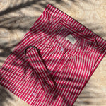 Robe Charlotte Fraise vue à plat sur le sol, avec sa ceinture